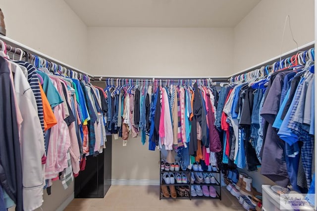 walk in closet featuring tile patterned flooring