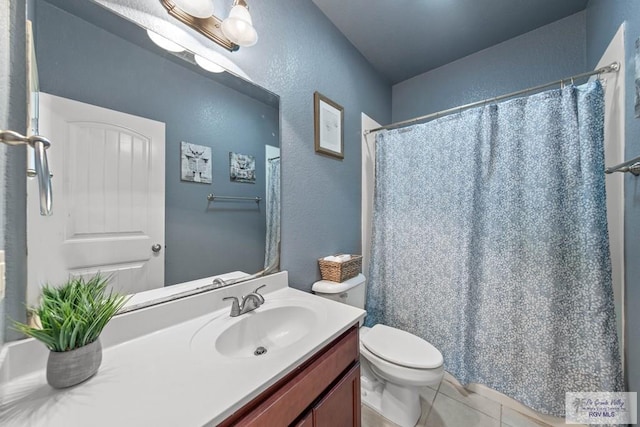 bathroom featuring a textured wall, toilet, a shower with shower curtain, vanity, and tile patterned floors