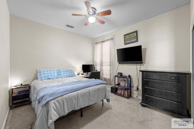 bedroom with a ceiling fan, carpet flooring, visible vents, and baseboards