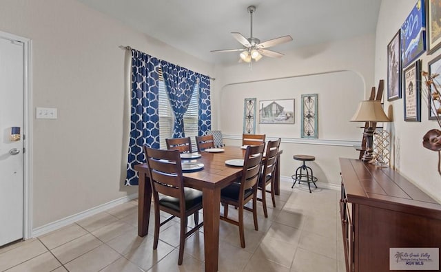 dining area featuring ceiling fan, light tile patterned floors, and baseboards