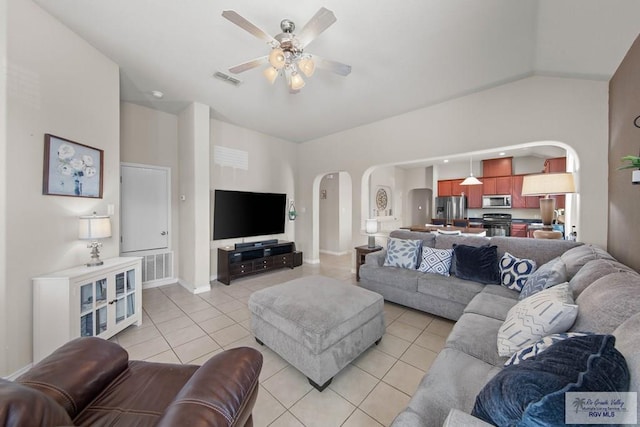 living room featuring light tile patterned floors, visible vents, arched walkways, and a ceiling fan