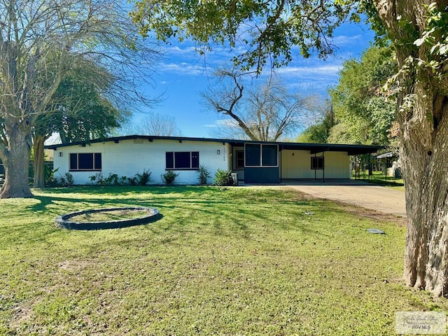 ranch-style home with a carport and a front lawn