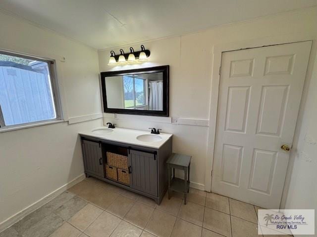 bathroom with tile patterned flooring, vanity, and plenty of natural light