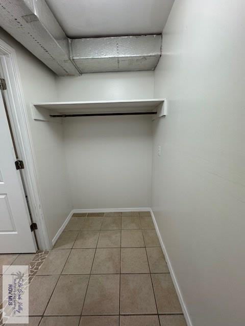 spacious closet featuring light tile patterned floors