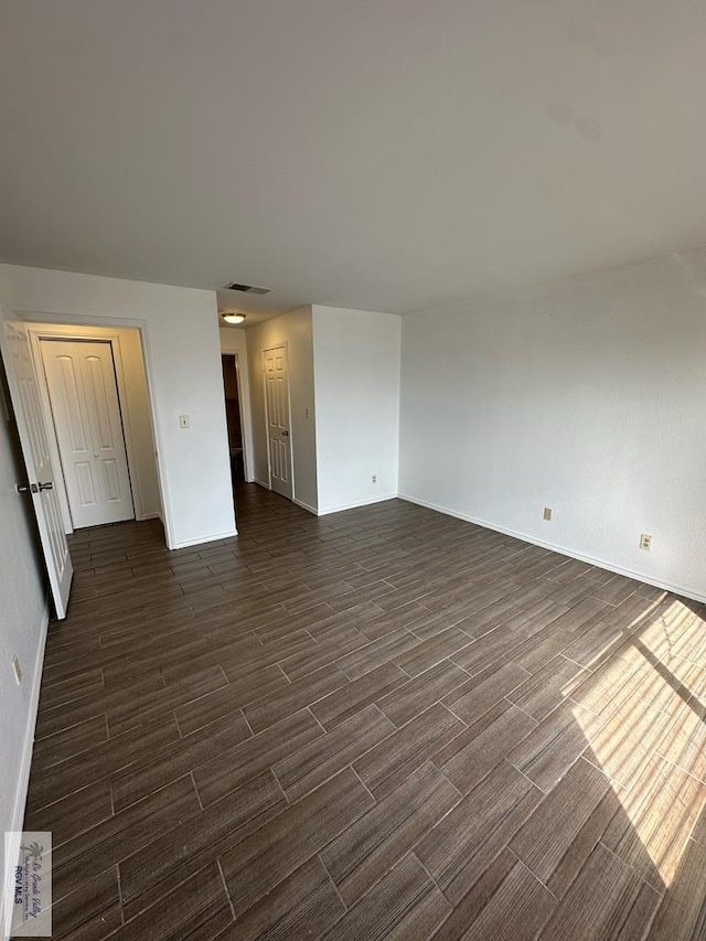 unfurnished living room featuring dark hardwood / wood-style floors