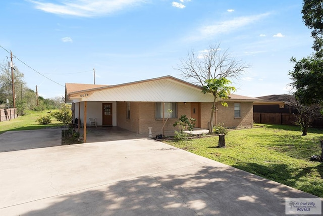 view of front of home with a front yard and a carport