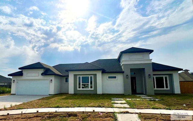 view of front facade with a front yard and a garage