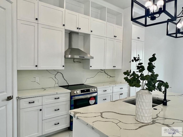 kitchen with white cabinets and wall chimney exhaust hood