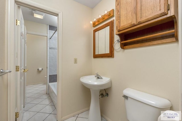 bathroom featuring tile patterned flooring, shower / tub combination, and toilet