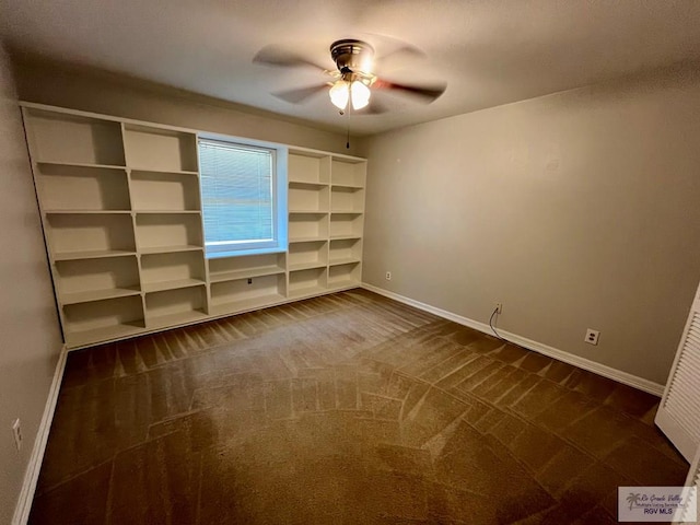 interior space featuring ceiling fan and dark carpet