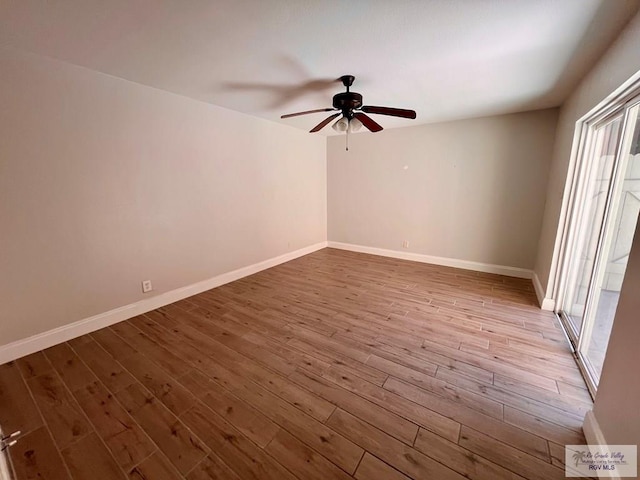 empty room with ceiling fan and hardwood / wood-style flooring