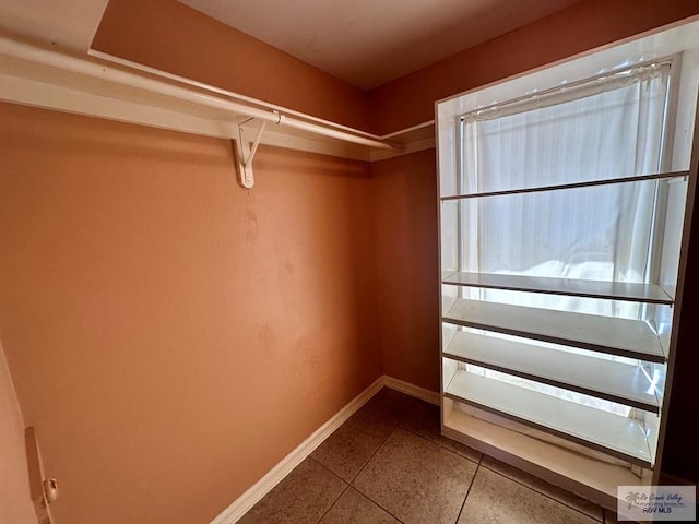 walk in closet featuring tile patterned flooring