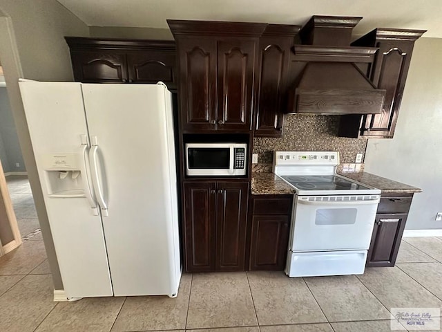 kitchen featuring dark brown cabinets, white appliances, and backsplash