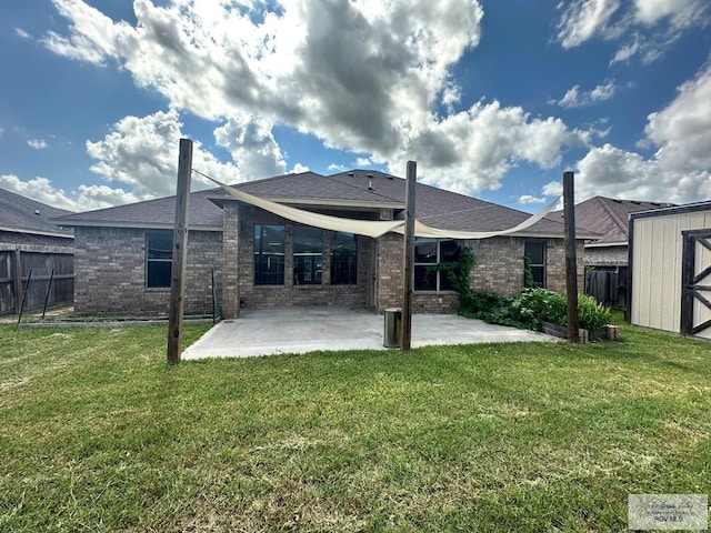 rear view of house with a patio area and a yard