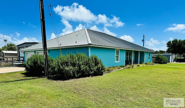 view of side of home with a yard