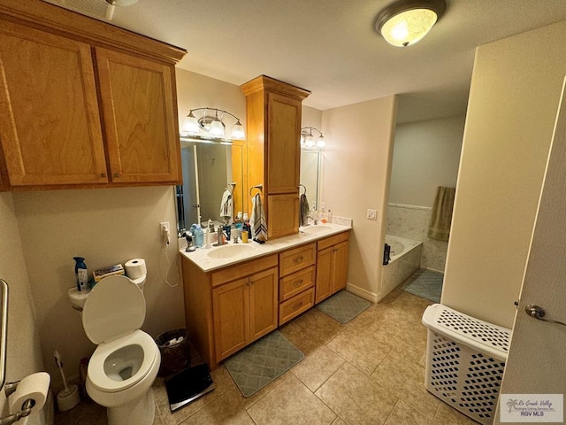 bathroom with vanity, tile patterned floors, and a tub