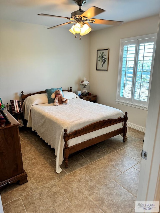 bedroom with ceiling fan and light tile patterned flooring