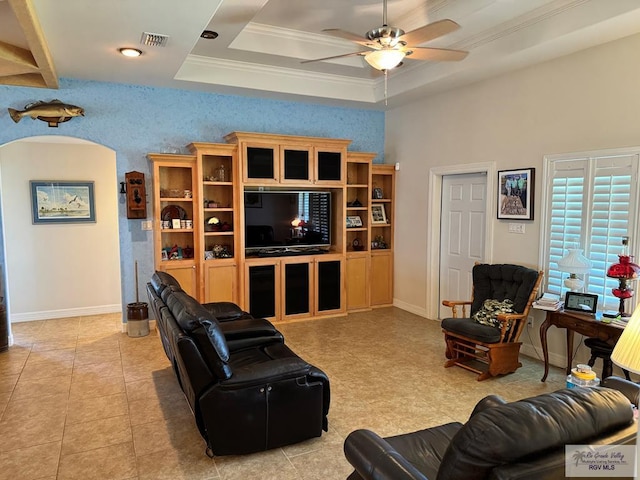 tiled living room with a tray ceiling, ceiling fan, and crown molding