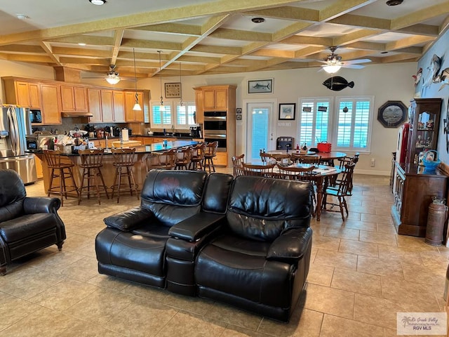 living room with a healthy amount of sunlight, light tile patterned floors, and coffered ceiling