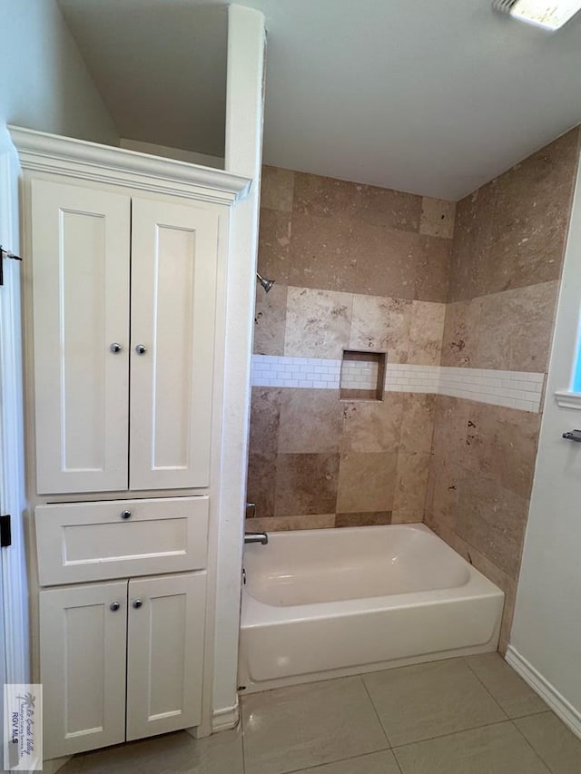 bathroom with tile patterned floors and tiled shower / bath