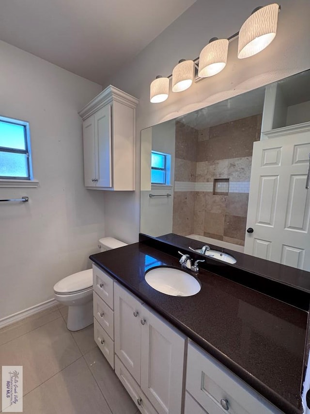 bathroom featuring tile patterned flooring, vanity, and toilet