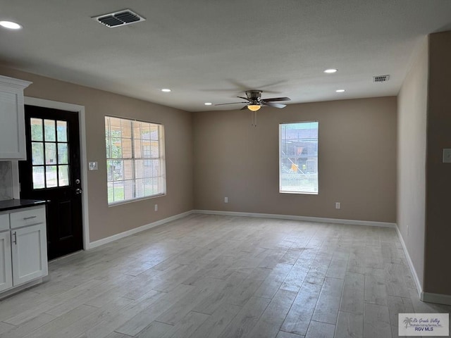 interior space with ceiling fan, light wood-style flooring, baseboards, and recessed lighting