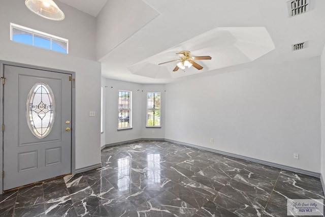 9315 Los Olmos Dr, Los Fresnos, TX 78566 - foyer entrance featuring a raised ceiling, a ceiling fan, and marble finish flooring