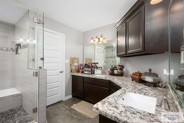 bathroom featuring vanity and a shower with door