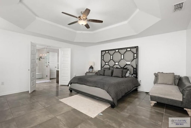 bedroom with a raised ceiling, ceiling fan, and ensuite bathroom