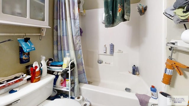 full bath featuring toilet and shower / tub combo with curtain