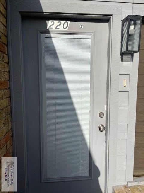 entrance to property with brick siding