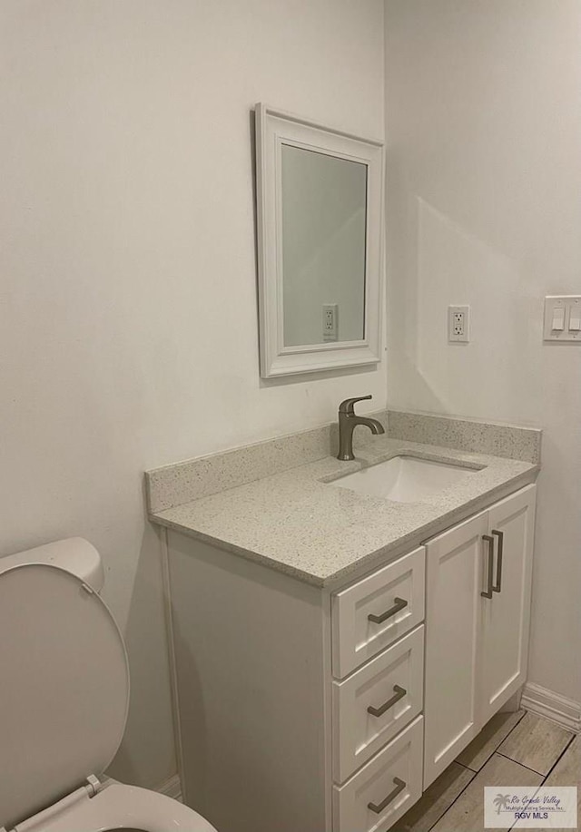 220 Country Club Rd Unit 2, Brownsville, TX 78520 - bathroom featuring baseboards, vanity, and toilet