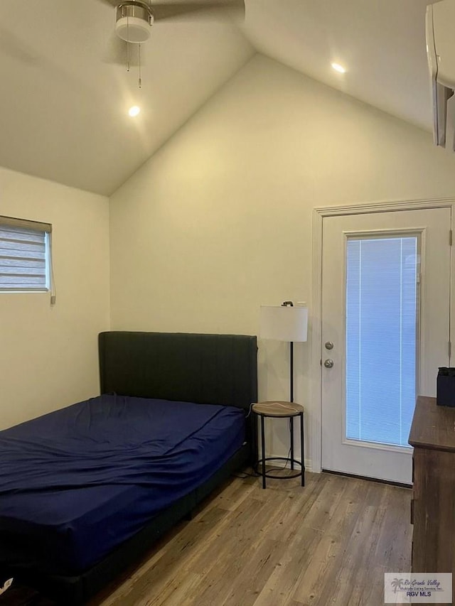 bedroom featuring lofted ceiling, a ceiling fan, and wood finished floors