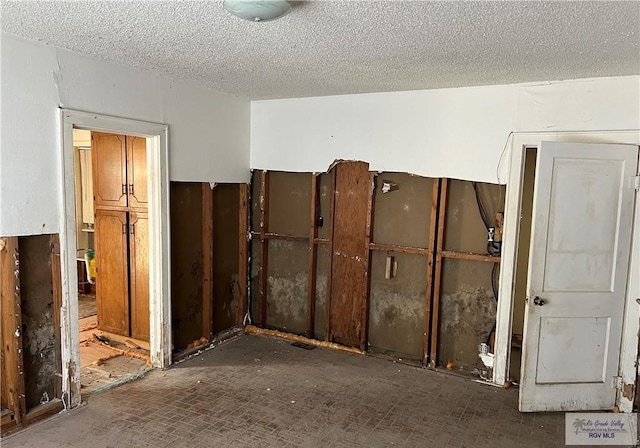 miscellaneous room featuring a textured ceiling