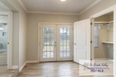 doorway to outside with crown molding, french doors, and light hardwood / wood-style floors