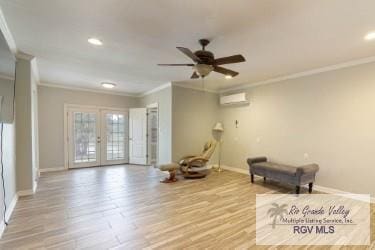 unfurnished room featuring french doors, an AC wall unit, ceiling fan, light wood-type flooring, and ornamental molding