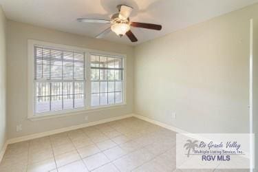 empty room with ceiling fan and light tile patterned flooring