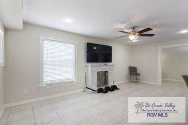 living room with a fireplace and ceiling fan