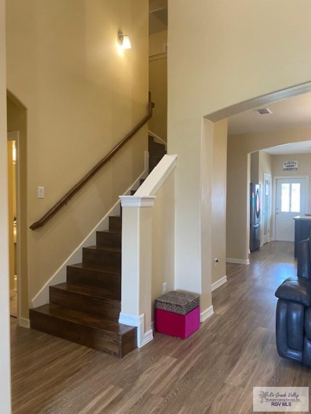 stairs featuring hardwood / wood-style floors