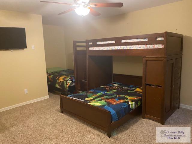 bedroom featuring light colored carpet and ceiling fan