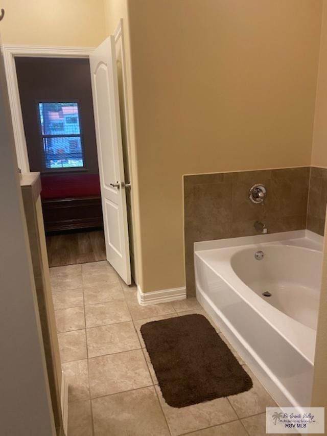 bathroom featuring tile patterned floors and a bathing tub