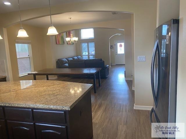 kitchen with an inviting chandelier, refrigerator, hanging light fixtures, dark hardwood / wood-style flooring, and dark brown cabinetry