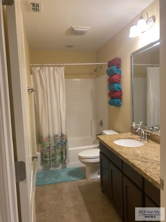 full bathroom featuring tile patterned floors, vanity, shower / bath combination with curtain, and toilet