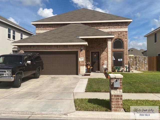 view of front of property featuring a garage and a front yard