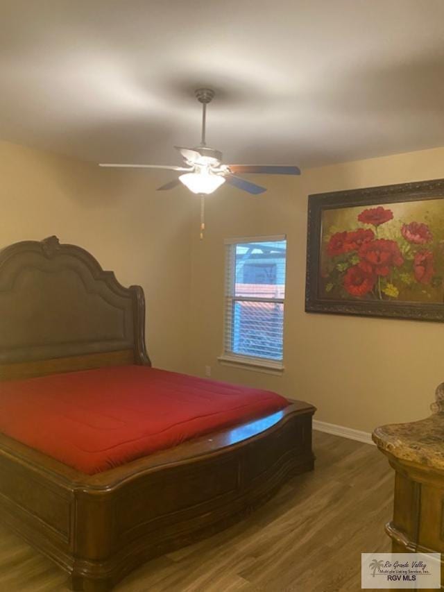 bedroom featuring dark hardwood / wood-style flooring, ceiling fan, and pool table