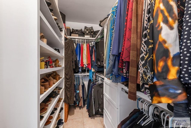 walk in closet with light tile patterned floors