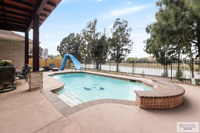 view of pool with a fenced in pool, a water slide, a fenced backyard, and a patio area