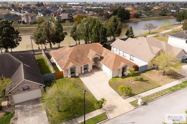 birds eye view of property with a residential view and a water view