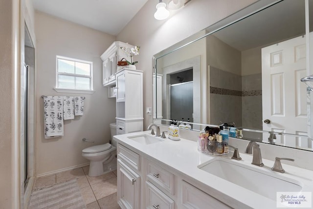 full bathroom with tile patterned flooring, toilet, a stall shower, and a sink