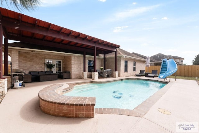 view of pool featuring a fenced in pool, an outdoor living space, a water slide, fence, and a patio